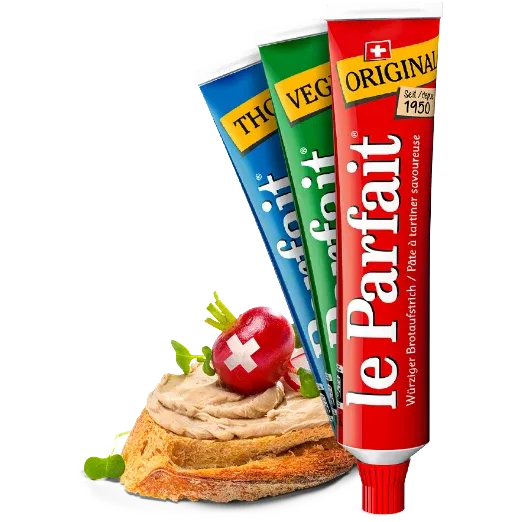 Le Parfait in drei verschiedenfarbigen Tuben. Daneben eine Brotscheibe mit Le Parfait Aufstrich.